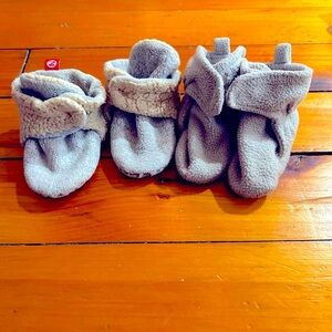 Two sets of gripper grey baby fleece booties.